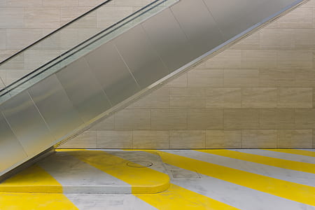 closeup photography of escalator beside wall thumbnail