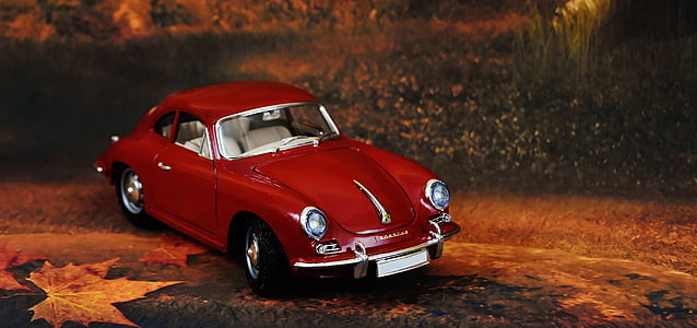 red Volkswagen beetle die-cast on ground thumbnail