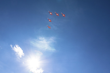 five red jetplane under white and sky during daytime thumbnail