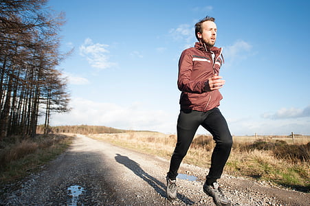 man running on pathway near trees thumbnail