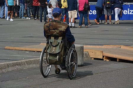 man sitting on green wheelchair thumbnail