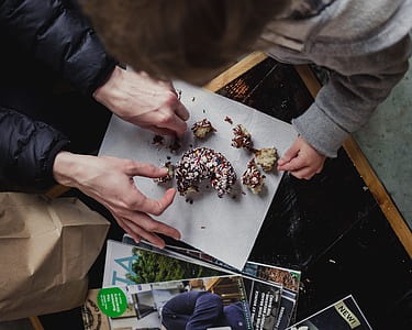 person cutting doughnut with sprinklers thumbnail