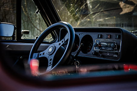 black car steering wheel inside a car thumbnail