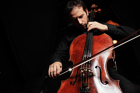 man sitting playing cello thumbnail