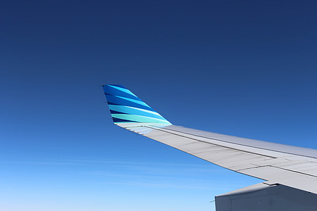 blue and white airplane wing thumbnail
