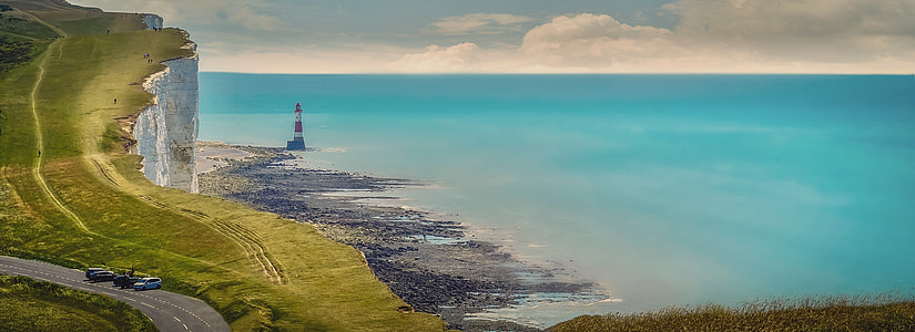 aerial photography of cliff and sea during daytime thumbnail