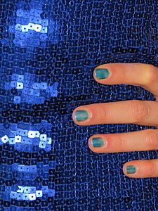 person holding blue sequinned top thumbnail