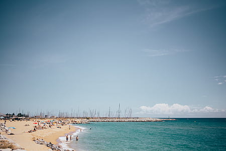 Panoramic view of a Spanish beach with tourists on a bright sunny day thumbnail