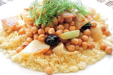 cooked rice topped with beans on round white ceramic plate thumbnail
