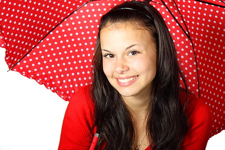 woman holding red and white polka-dot umbrella thumbnail