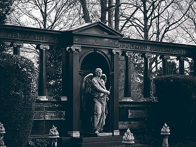 grayscale photo of angel standing and holding sword statue thumbnail