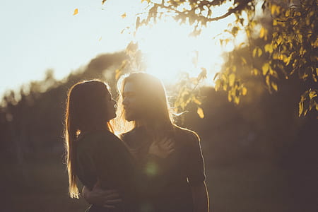 woman and man facing each other near tree thumbnail