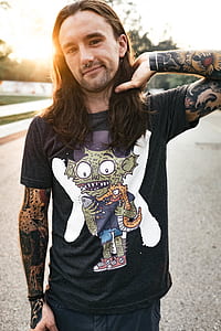 man wearing black crew-neck shirt while holding his hair thumbnail