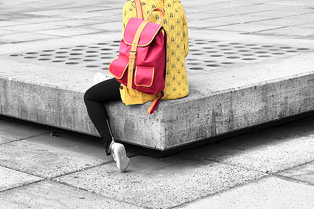 person wearing yellow shirt sitting on concrete floor thumbnail