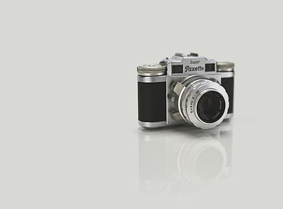 gray and black camera on white floor thumbnail