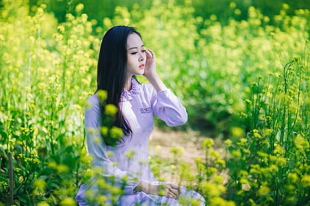 woman wearing gray long-sleeved shirt between grass thumbnail