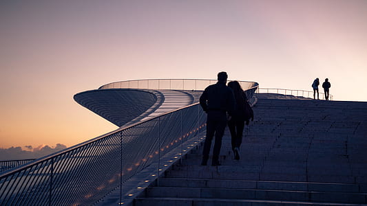 man and woman standing on stairs thumbnail