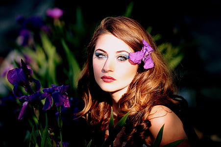 woman near purple iris flower field during daytime thumbnail