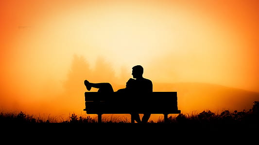 silhouette of man and woman sitting on bench thumbnail