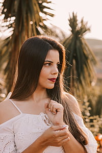 woman standing near green palm tree thumbnail