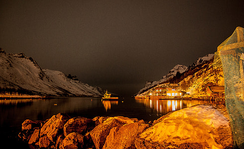 boat in the middle of body of water near dock thumbnail