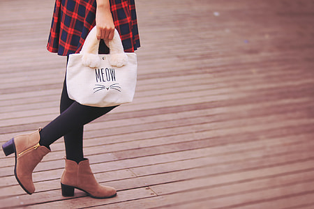 woman in red plaid skirt carrying white Meow tote bag thumbnail