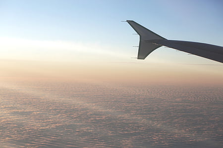 person taking photo of the sky inside the plane during daytime thumbnail