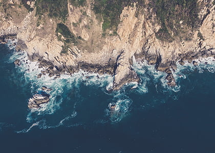 aerial photography of sea near mountain thumbnail