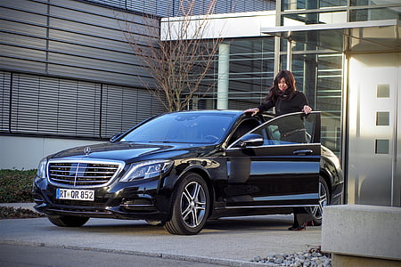 woman standing next to a car thumbnail