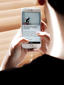 person holding turned-on iPhone with scooter display thumbnail
