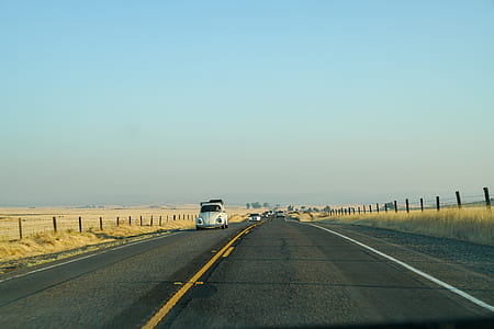 white Volkswagen beetle on road during daytime thumbnail