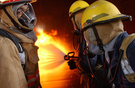 fire men firing water to put out fire during night time thumbnail
