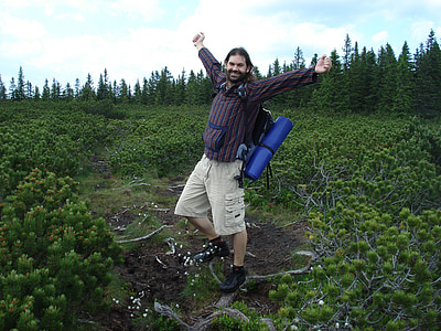 man standing on green leafed plant during daytime thumbnail