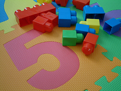 assorted-colored interlock toys on jigsaw mat thumbnail