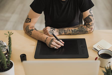 Tattood Man Using Creative Technology Photo thumbnail