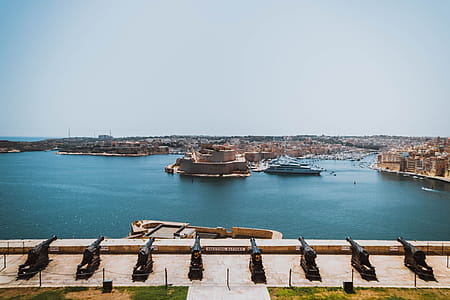 Boat on Body of Water Dnear Concrete Building thumbnail