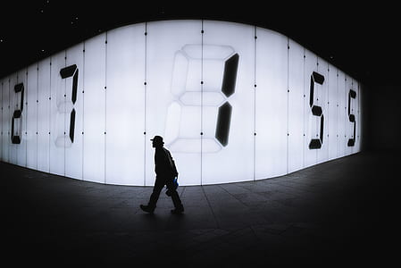 silhouette of man walking on road thumbnail
