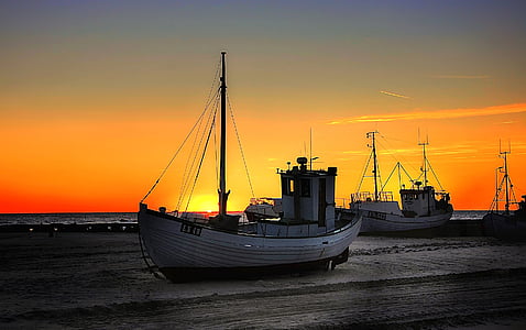 white boat on shore during sunset thumbnail