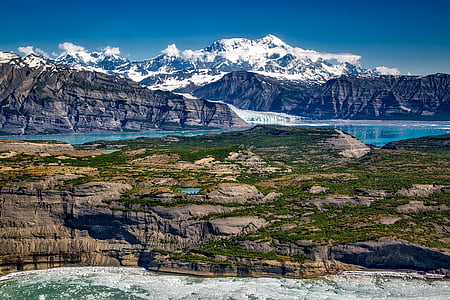 landscape photography of mountain alps near blue lake thumbnail