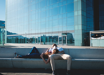 woman sleeping on man's lap near glass window building thumbnail