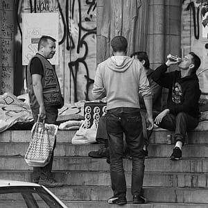 several men sitting on staircase thumbnail