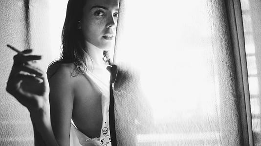 woman in grayscale photo wearing white shirt thumbnail