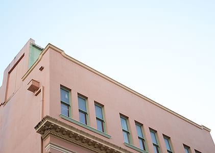 low-angle photography of brown concrete building during daytome thumbnail