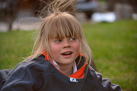 girl in jacket near grass thumbnail