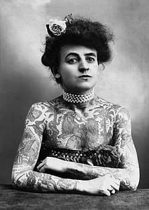 grayscale photograpy of woman covered with tattoo thumbnail