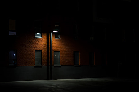 street light on brown wooden commercial building during nighttime thumbnail