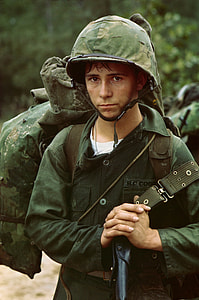 man wearing military helmet and uniform while carrying bag thumbnail