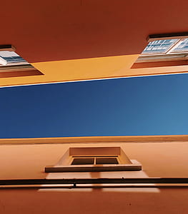 worm eyes view of orange building thumbnail