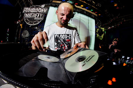 male DJ holding disc inside room thumbnail