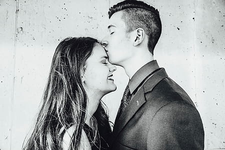 greyscale photo of man kissing the forehead of woman thumbnail